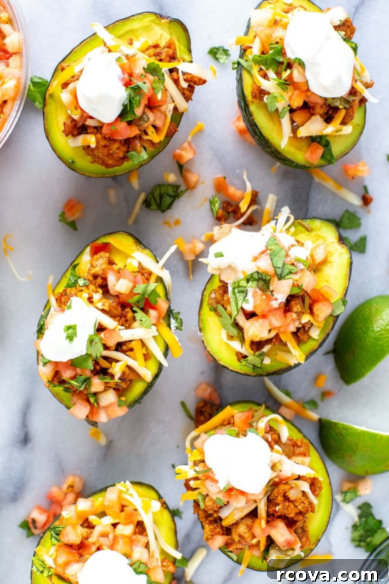 Avocado Taco Boats 9 Beautifully presented Low Carb Taco Stuffed Avocados on a wooden board.