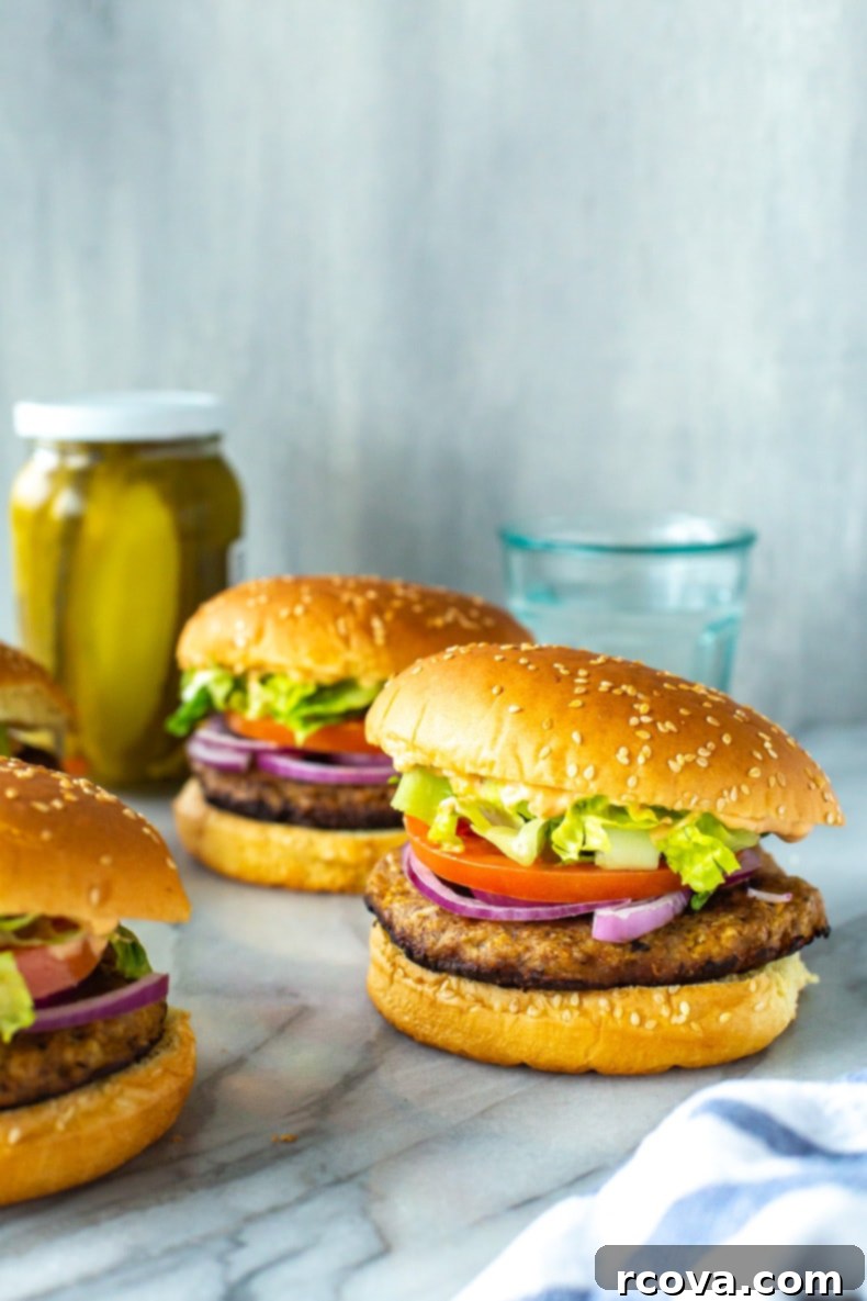 Succulent Turkey Burgers The Ultimate Recipe 10 A beautifully plated juicy turkey burger with crisp toppings, a side of sweet potato fries, and a small side salad.