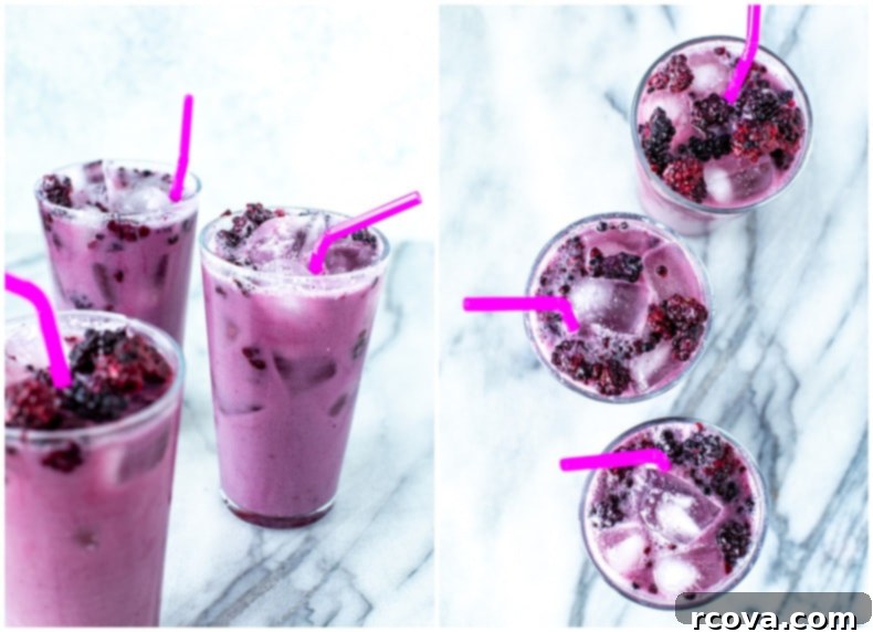 Copycat Starbucks Purple Drink Recipe 8 Close-up of a Starbucks Violet Drink with ice and a few fresh blackberries on top, showing the beautiful gradient.