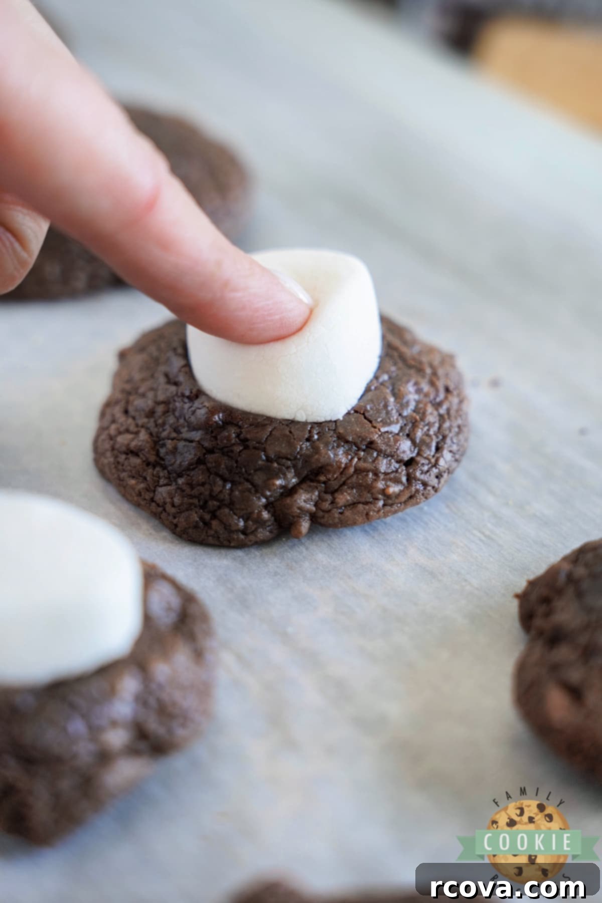 S'mores Brownie Cookies 10 Press half of marshmallow on top of chocolate cookie.