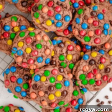 Chewy Chocolate M&M Pudding Cookies 6 chocolate pudding cookies topped with M&Ms on a cooling rack