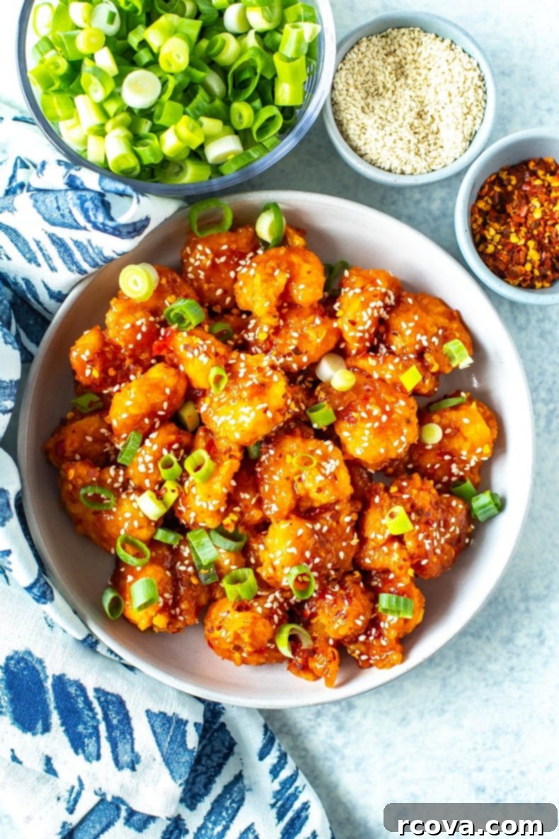 Blazing Firecracker Shrimp 2 Crispy Firecracker Shrimp coated in a glossy, sweet and spicy sauce, garnished with green onions and sesame seeds.