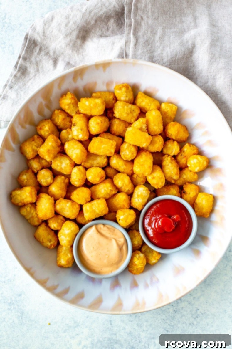 Ultimate Crispy Air Fryer Tater Tots 2 Crispy Air Fryer Tater Tots served with homemade dipping sauce