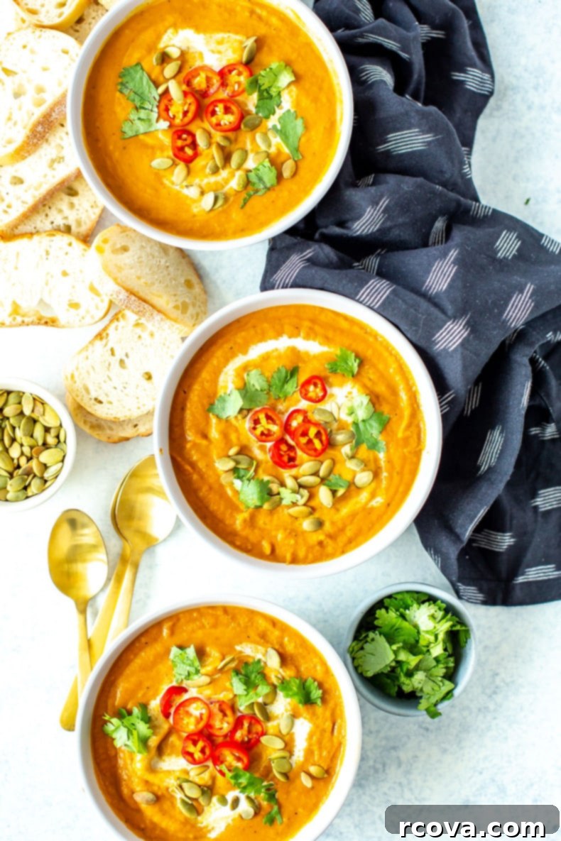Velvety Spiced Pumpkin Curry Soup 2 Delicious Creamy Pumpkin Curry Soup garnished with fresh herbs, perfect for autumn