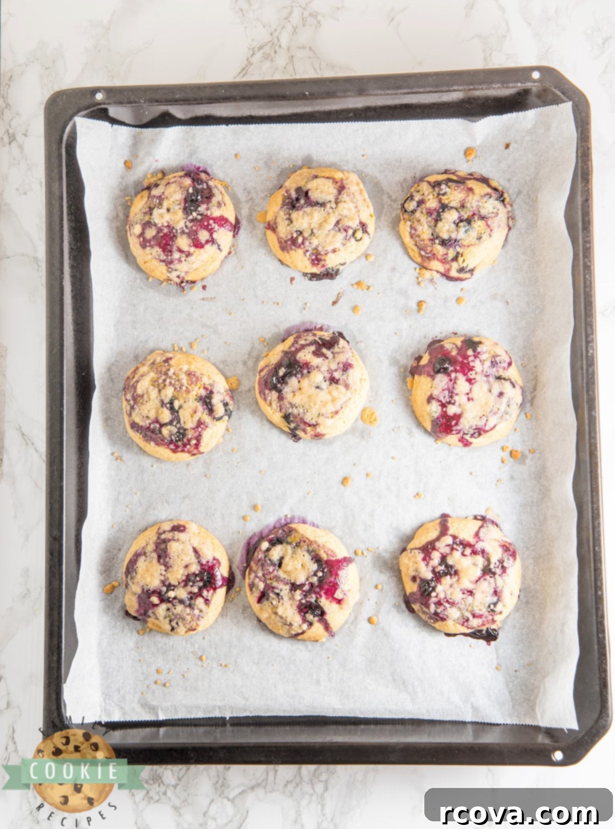 Sunshine Berry Muffin Cookies 13 Beautifully baked blueberry muffin cookies with a hint of lemon, showcasing their golden streusel and jam centers.