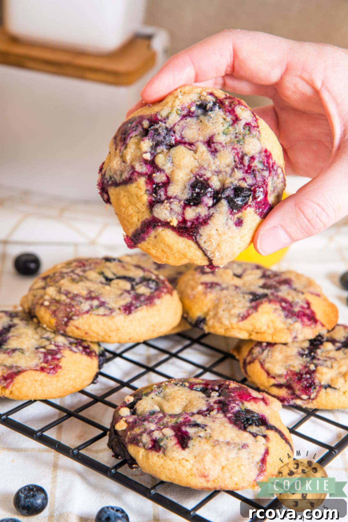 Sunshine Berry Muffin Cookies 15 A close-up of a single Lemon Blueberry Muffin Cookie, showcasing the streusel and blueberry jam filling.