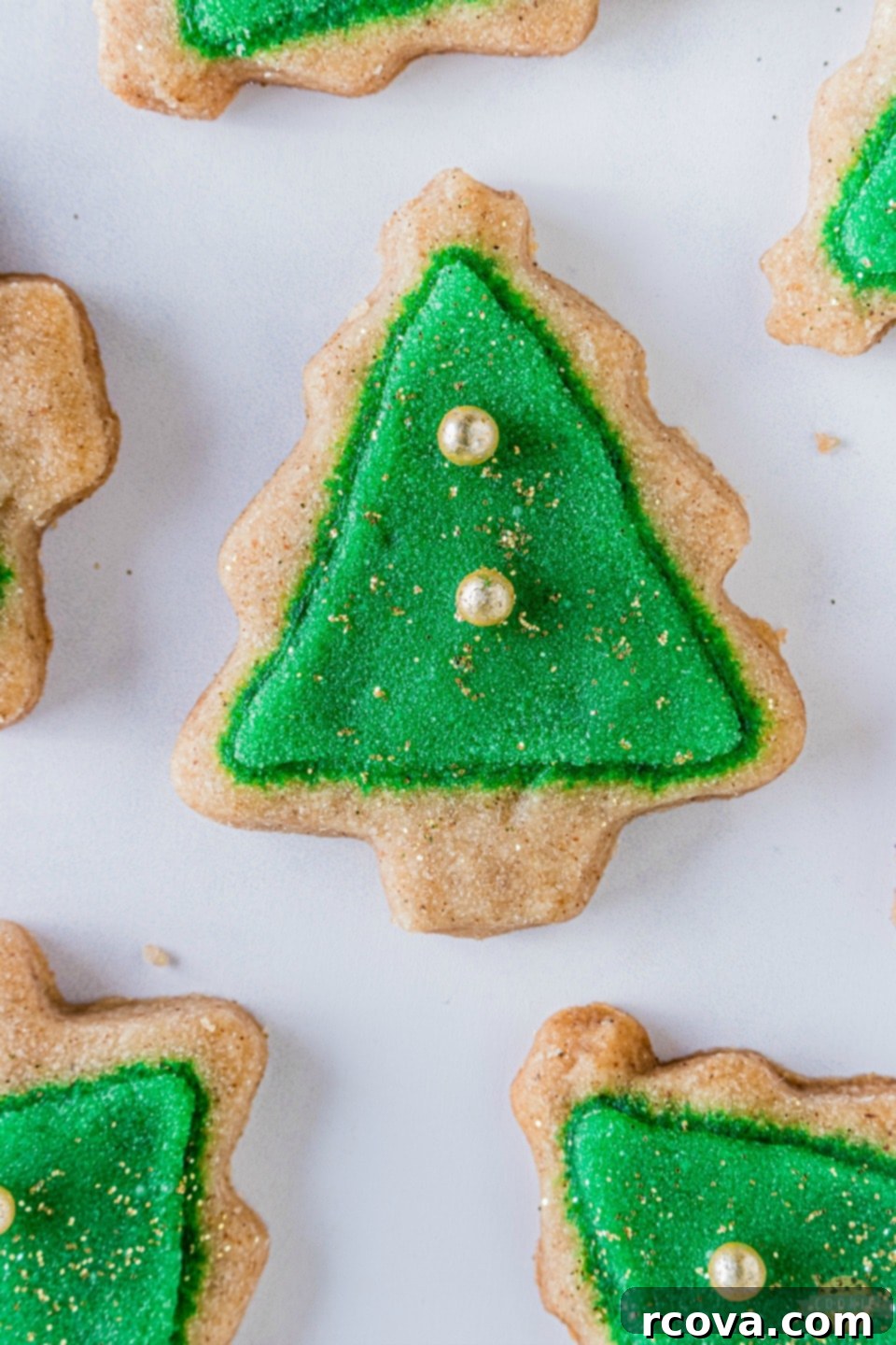Holiday Spiced Shortbread Delights 7 A beautifully arranged plate of Spiced Christmas Shortbread Cookies, some plain and some iced, with festive decorations.