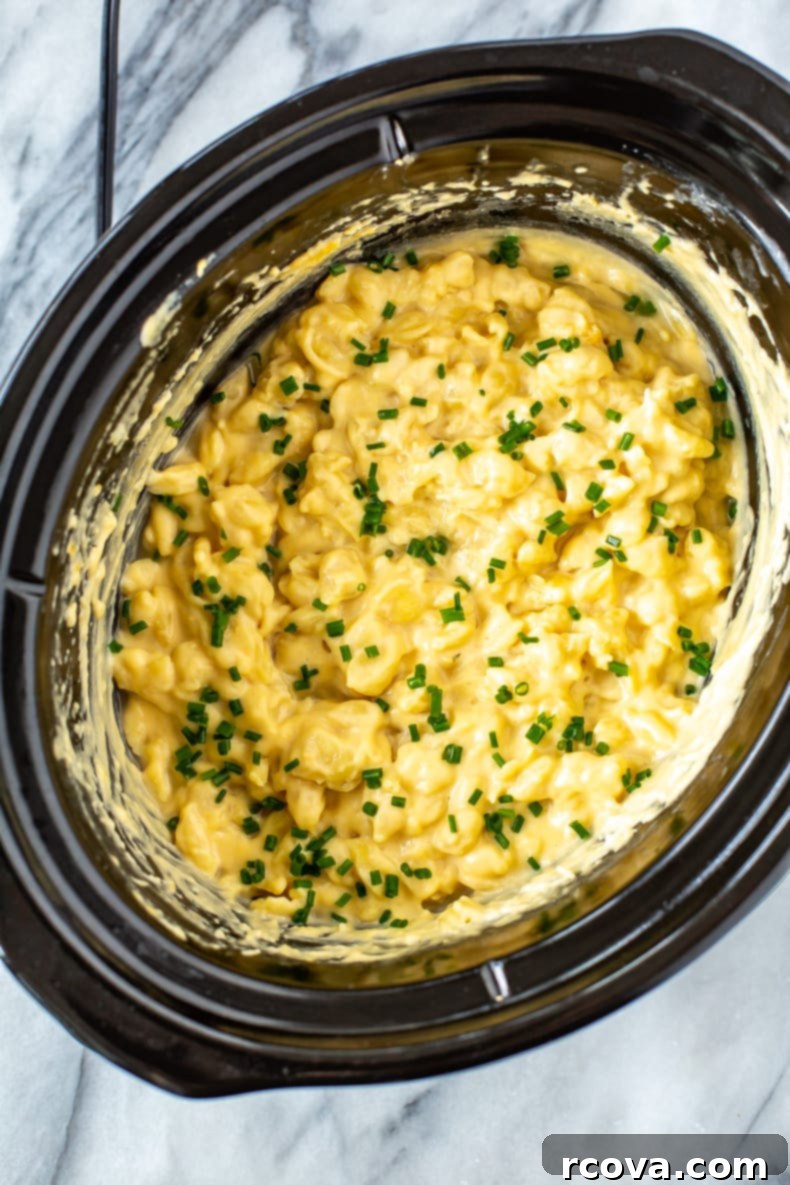 Velvety Slow Cooker Mac and Cheese 2 Classic Slow Cooker Mac and Cheese in a crock pot, ready to serve.