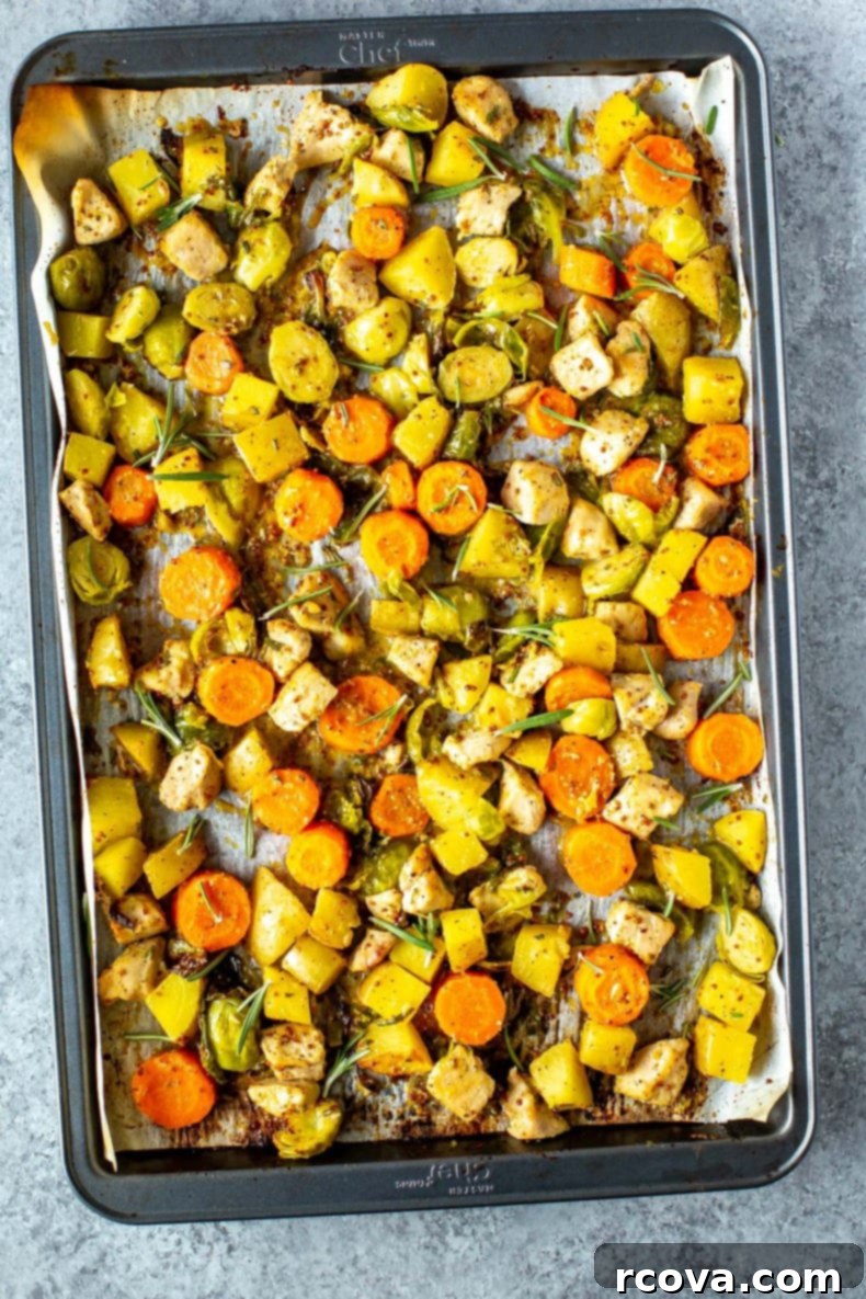 Golden Baked Honey Mustard Chicken 2 Baked Honey Mustard Chicken with roasted potatoes and brussels sprouts on a sheet pan, ready to serve.
