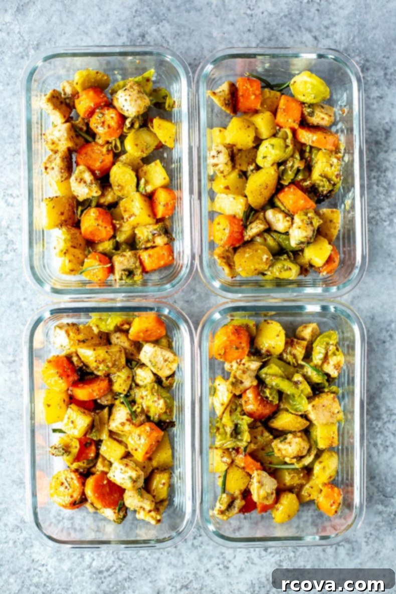 Golden Baked Honey Mustard Chicken 9 Two glass meal prep bowls filled with baked honey mustard chicken and vegetables, perfect for a healthy lunch or dinner.