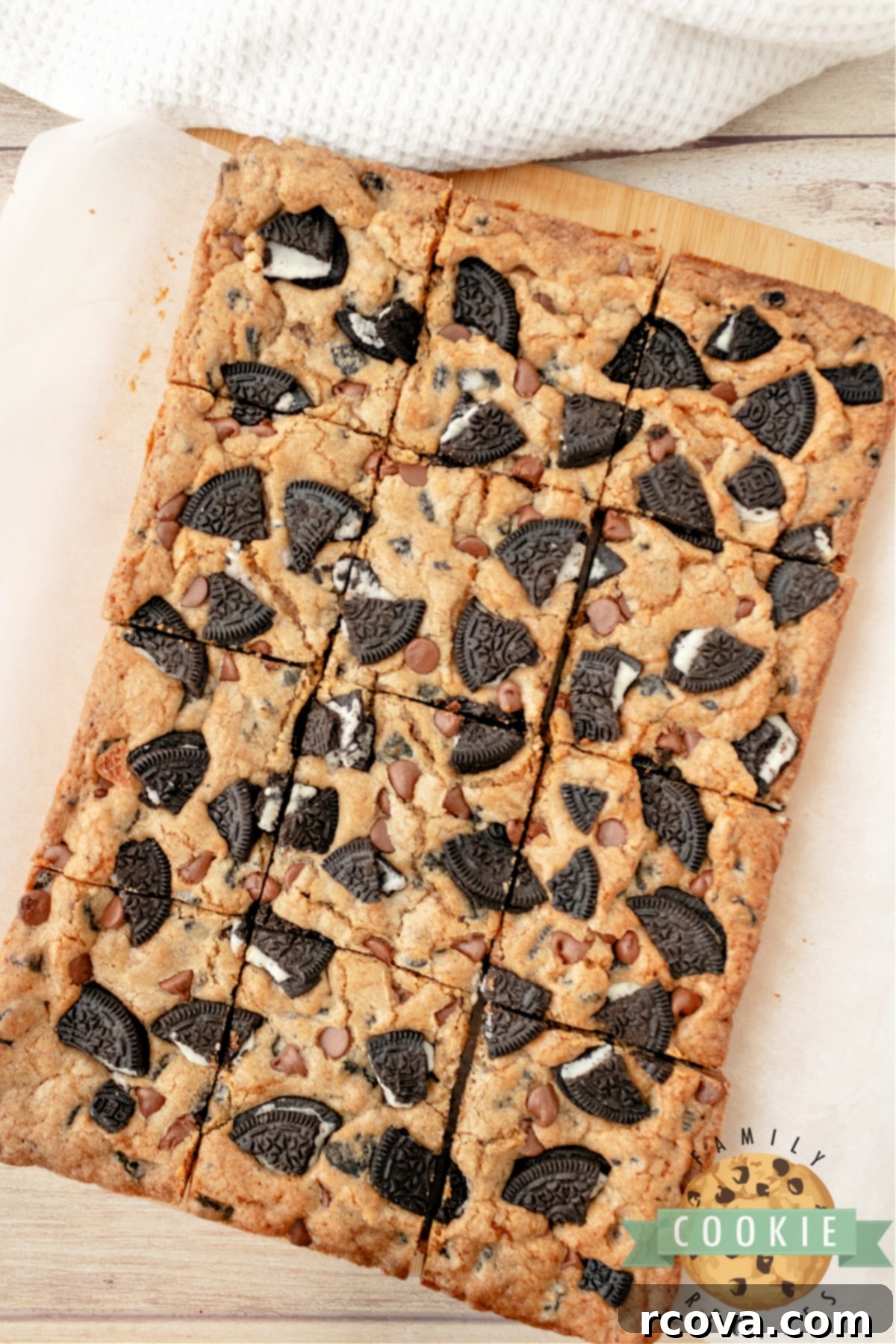 Ultimate Oreo Bars 3 A tray of freshly baked cookie bars studded with Oreo cookie pieces, ready to be cut.