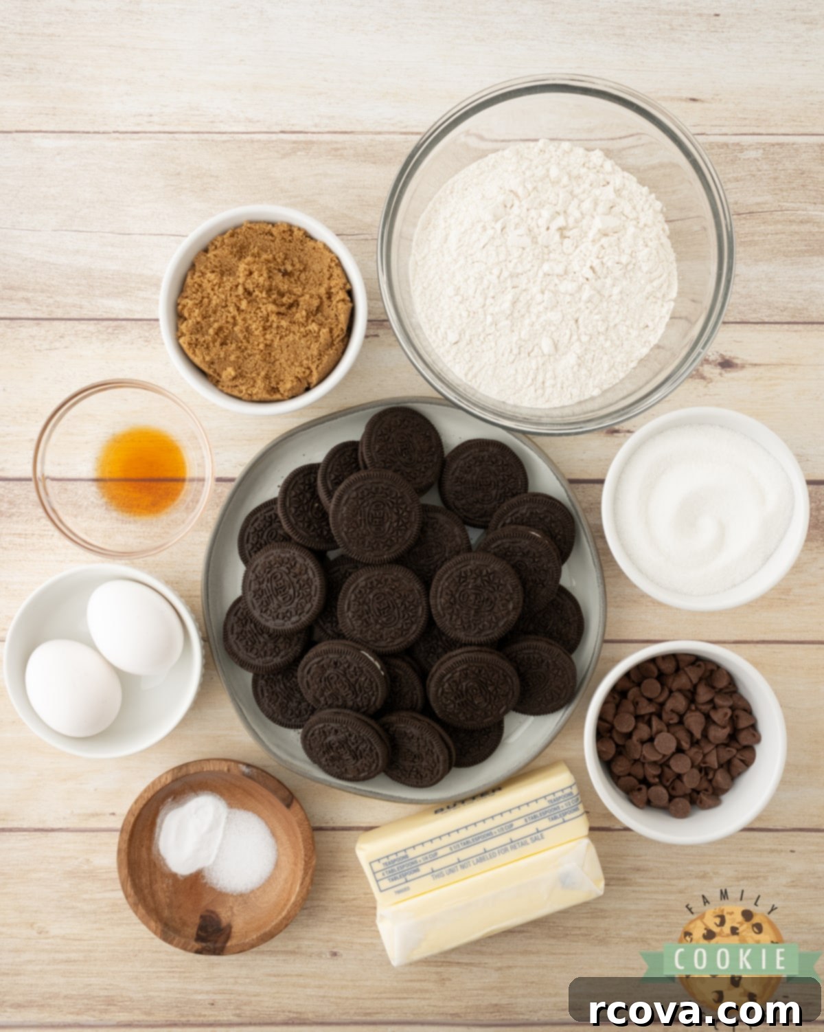 Ultimate Oreo Bars 4 All the key ingredients for Oreo Cookie Bars laid out on a kitchen counter: Oreos, flour, butter, sugars, eggs, vanilla, and chocolate chips.