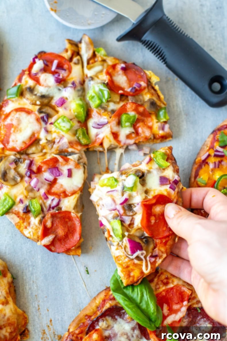 Quick and Easy Pita Pizza 3 Ways 8 Close-up of a Tex Mex pita pizza with cheddar cheese, corn, red pepper, red onion, and jalapenos