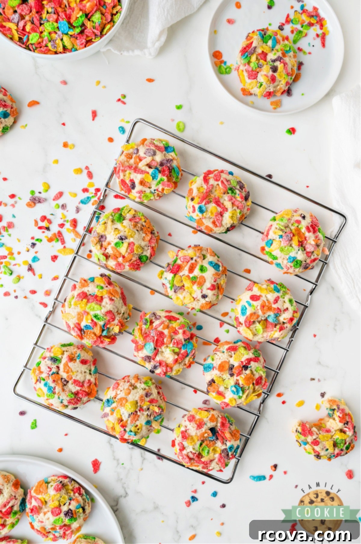Vibrant Cereal Cookie Delights 12 Warm, freshly baked Fruity Pebbles Cookies cooling on a wire rack.