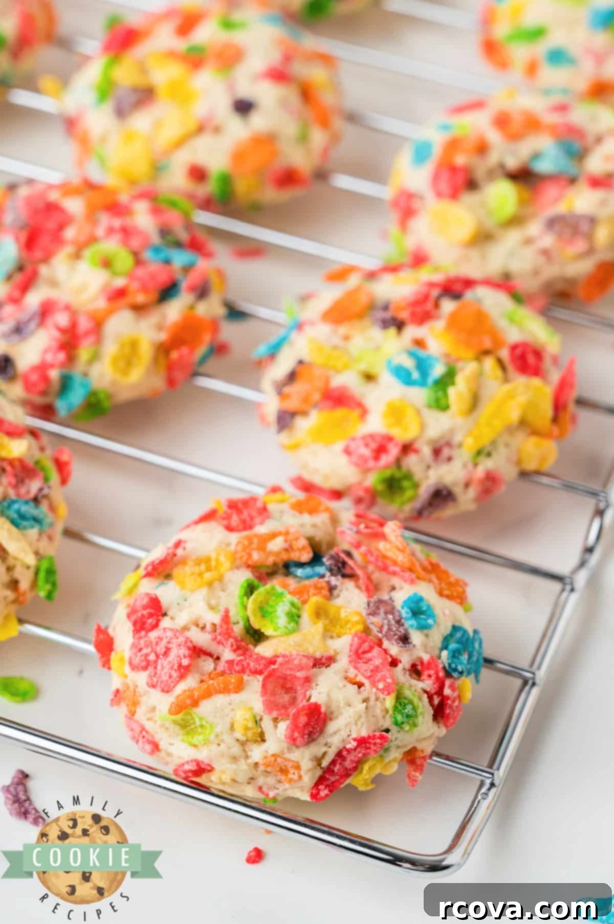 Vibrant Cereal Cookie Delights 4 Unbaked cookie dough balls generously coated in colorful Fruity Pebbles cereal.