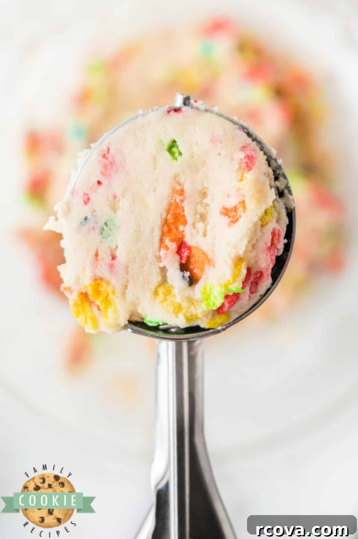Vibrant Cereal Cookie Delights 9 A cookie scoop holding a portion of Fruity Pebbles cookie dough.