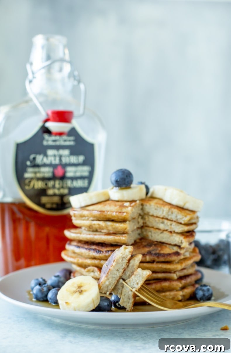 Wholesome 5-Ingredient Gluten-Free Banana Oat Pancakes 9 A close-up shot of a single fluffy banana oat pancake on a plate, highlighting its light texture and golden-brown edges.