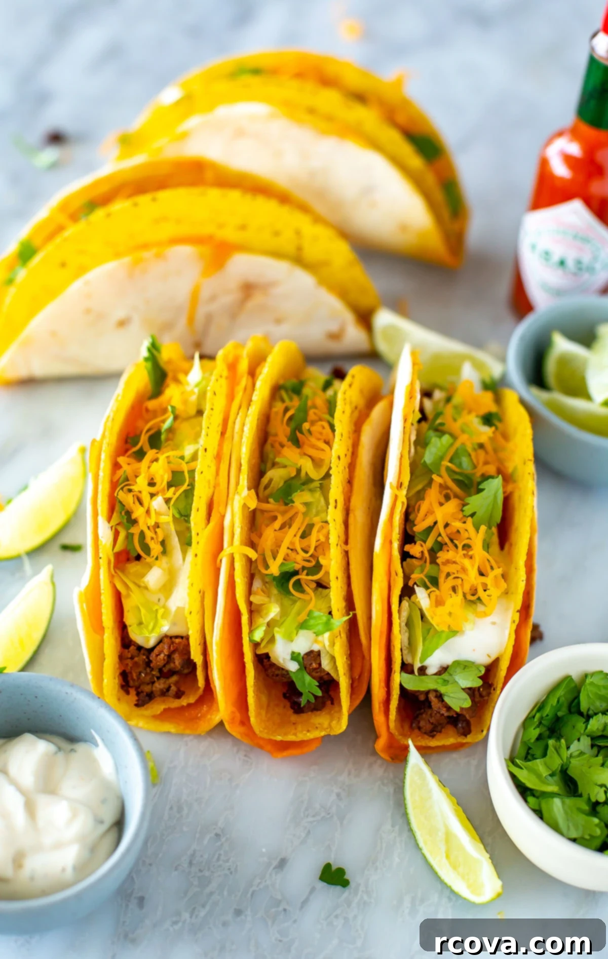 Copycat Cheesy Gordita Crunch Perfection 8 Three perfectly assembled cheesy gordita crunch tacos displayed side by side on a rustic wooden surface, highlighting their layered structure and vibrant fillings.