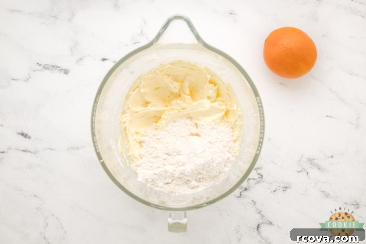 Decadent Orange Fudge Cookies 8 Mixing flour and baking soda into the wet cookie dough ingredients.