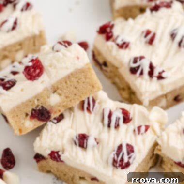 Irresistible White Chocolate Cranberry Cookie Bars 18 White Chocolate Cranberry Cookie Bars: Soft, chewy, with cream cheese frosting and white chocolate drizzle.