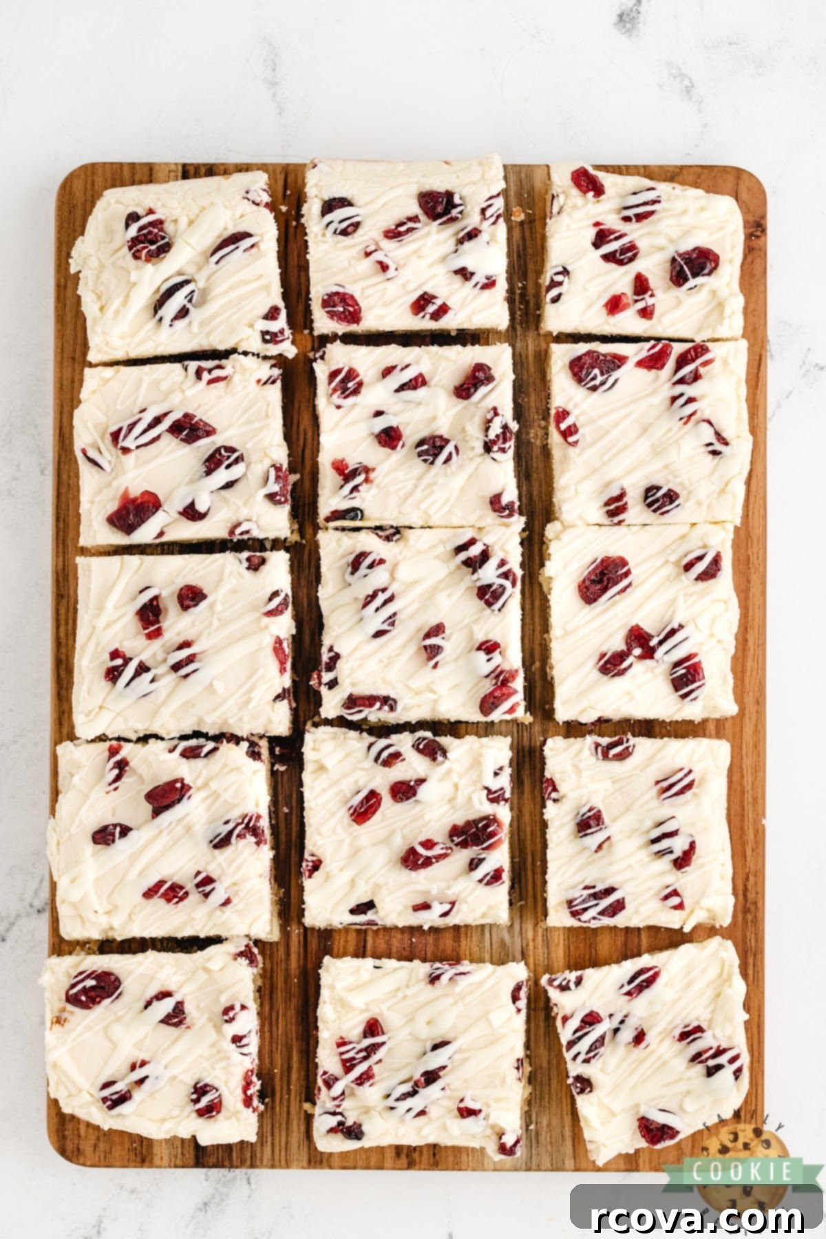 Irresistible White Chocolate Cranberry Cookie Bars 3 Close-up shot of cookie bars featuring creamy cream cheese frosting and vibrant dried cranberries, a delectable bar cookie recipe.