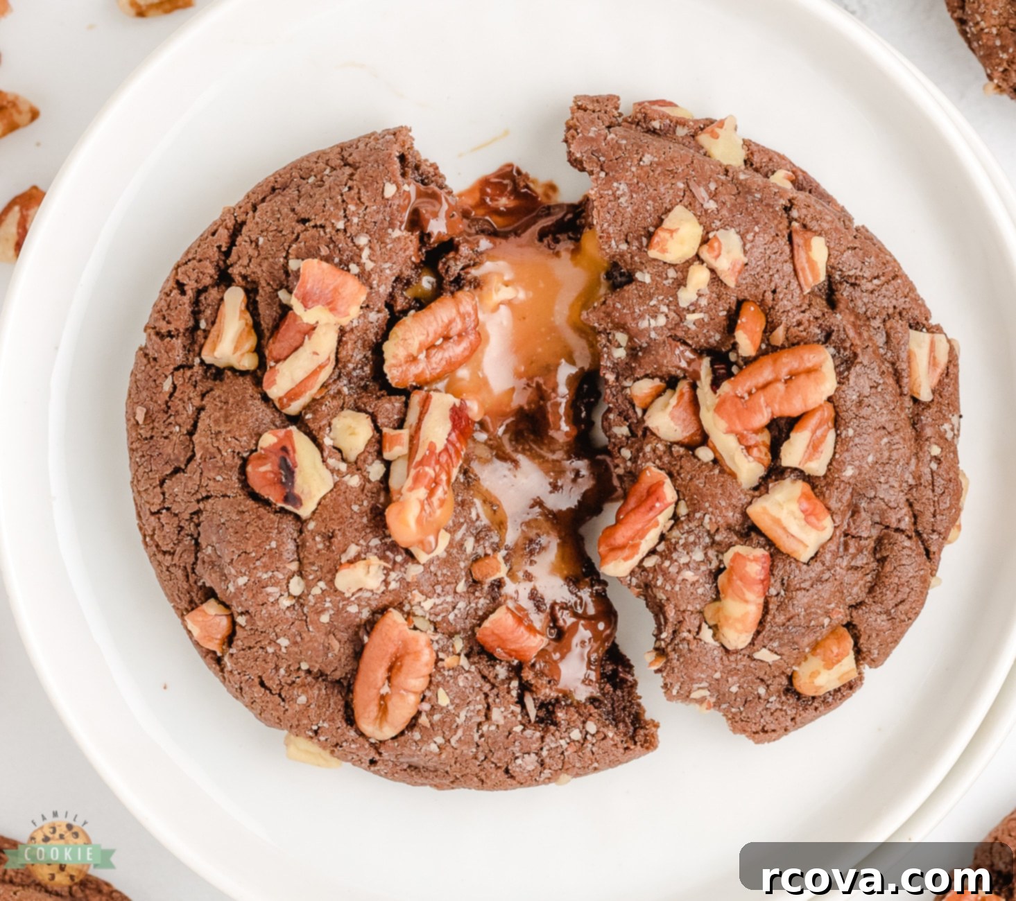 Gooey Caramel Pecan Chocolate Cookies 9 turtle cookie in half on a white plate