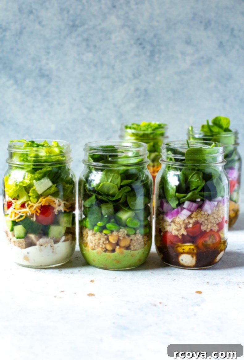 Over 25 Delicious No-Cook Recipes for Summer 21 3 mason jars in a row, each containing a different salad inside.