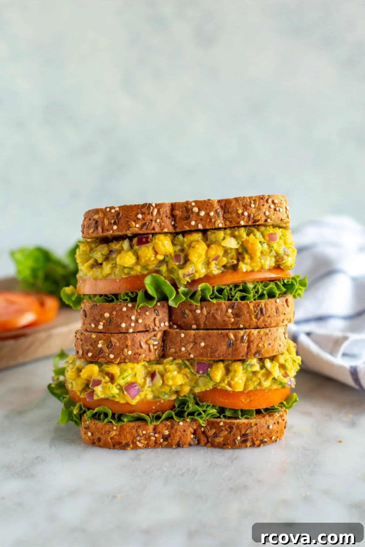 Over 25 Delicious No-Cook Recipes for Summer 10 Two chickpea tuna salad sandwiches stacked on top of each other.