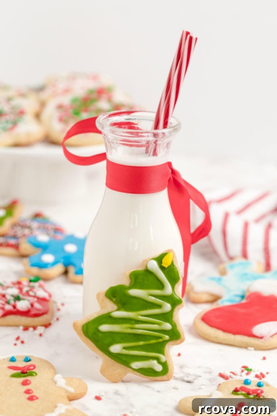 Crafting Christmas Cookie Magic 9 How to make Christmas Cut Out Cookies. A close-up of a gingerbread man cookie with white icing and red sprinkle buttons.