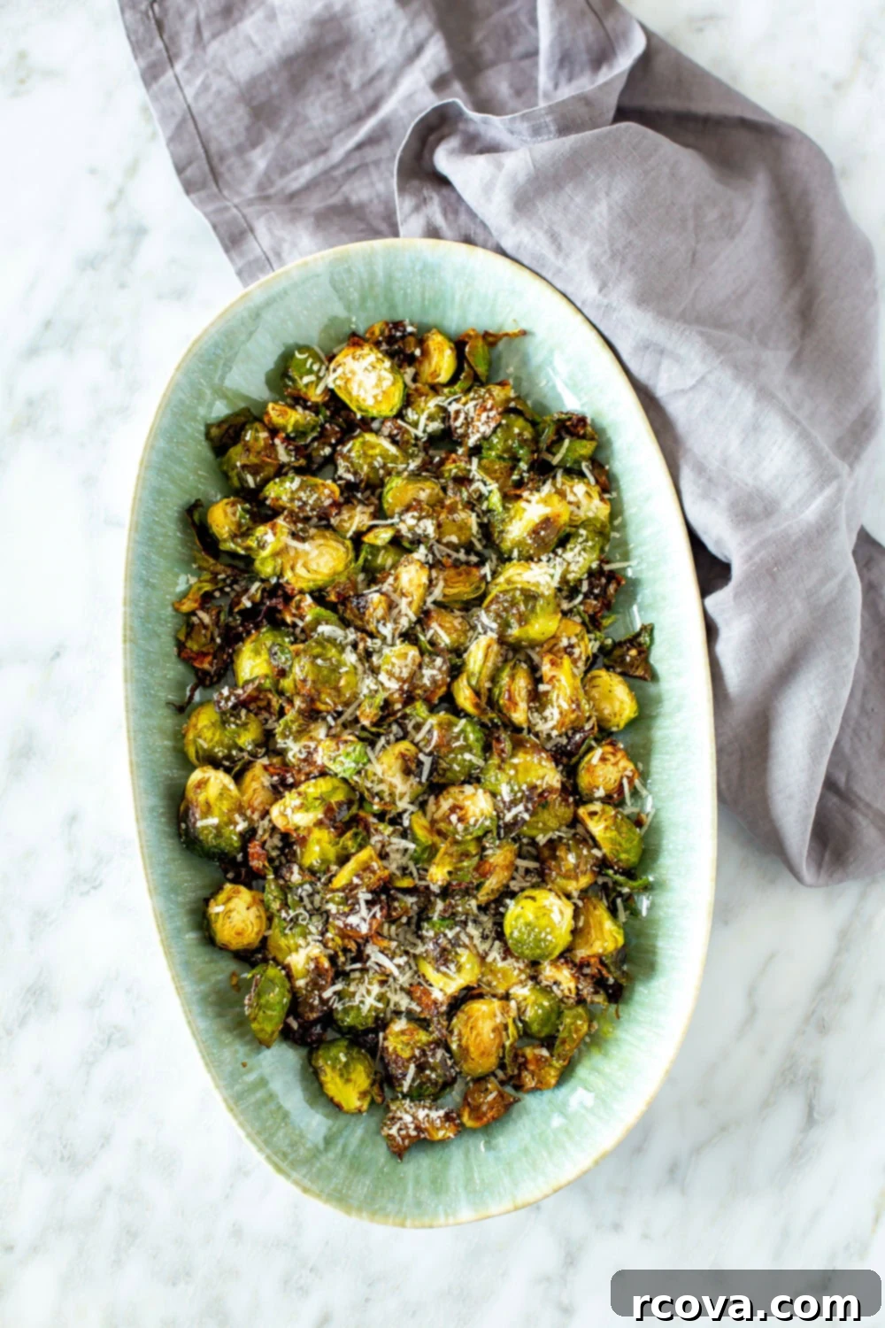 Ultimate Crispy Garlic Parmesan Air Fryer Sprouts 8 A large serving bowl filled with perfectly roasted and crispy Air Fryer Brussels Sprouts, garnished with fresh herbs and ready to be enjoyed.