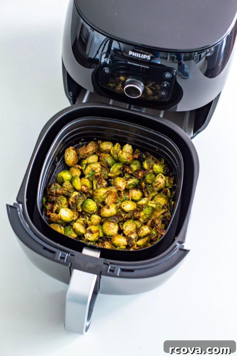 Ultimate Crispy Garlic Parmesan Air Fryer Sprouts 9 Crispy Air Fryer Brussels Sprouts with balsamic glaze and parmesan on a white plate