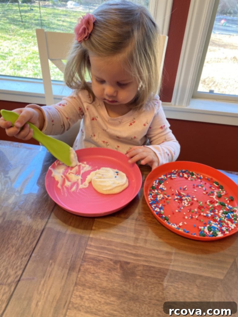 Wholesome Applesauce Oat Chocolate Chip Cookies 11 Little girl joyfully frosting sugar cookies