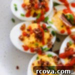 Fiery Sriracha Bacon Deviled Eggs 11 sriracha deviled eggs with bacon on a white plate