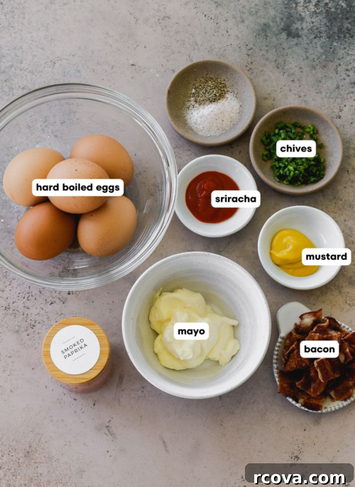 Fiery Sriracha Bacon Deviled Eggs 3 photo shot of all of the ingredients used to make sriracha deviled eggs with bacon: hard boiled eggs, mayo, sriracha, mustard, bacon, salt, pepper, paprika and chives.