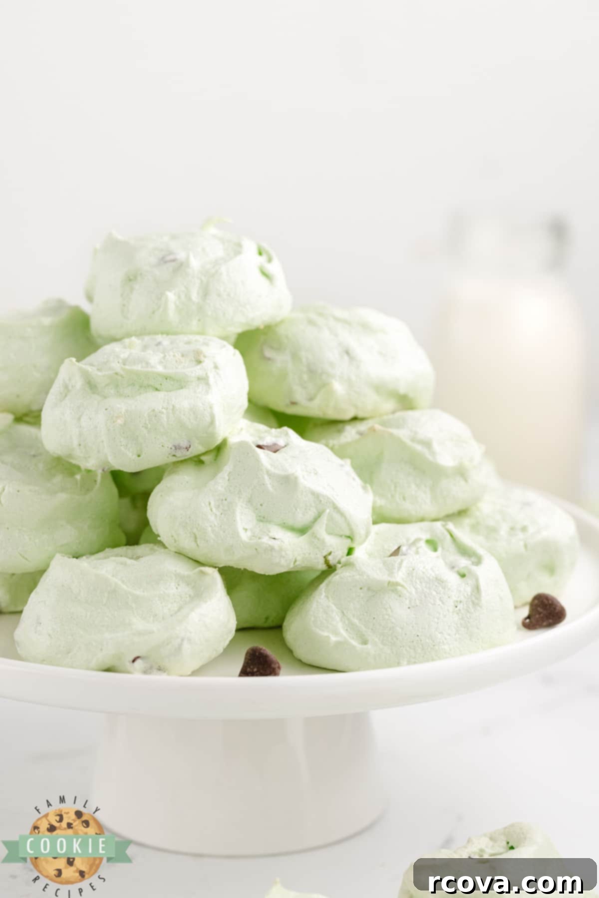 Cool Mint Chocolate Chip Meringue Clouds 12 A close-up shot of a single Mint chocolate chip meringue cookie, showing its vibrant green color and delicate, airy texture.