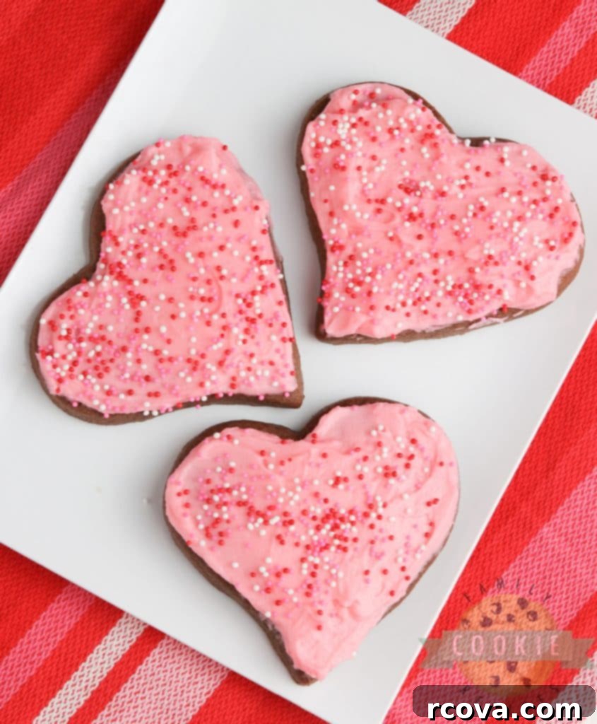 Irresistible Chocolate Sugar Cookies 9 A close-up of a beautifully decorated chocolate sugar cookie with sprinkles.
