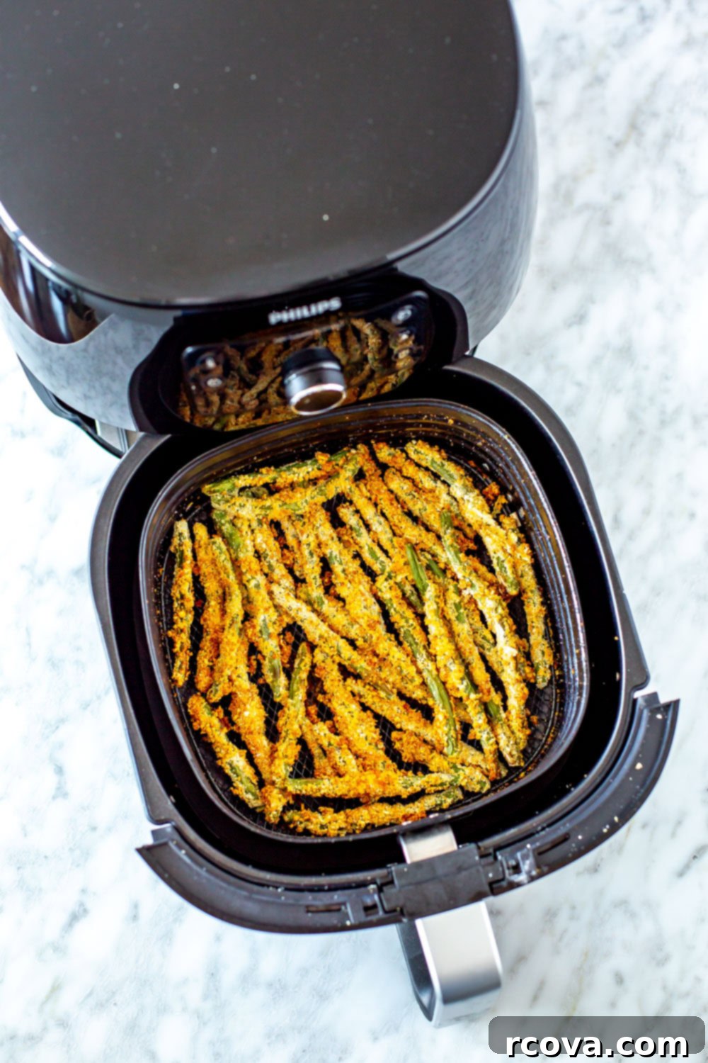 Crispy Green Bean Fries Air Fried or Baked 9 Crispiest Green Bean Fries in a bowl with a hand dipping one