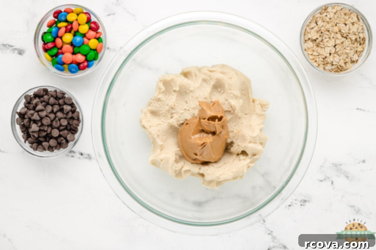 Easy 5-Ingredient Monster Cookies 6 Mixing creamy peanut butter with softened sugar cookie dough in a large bowl.