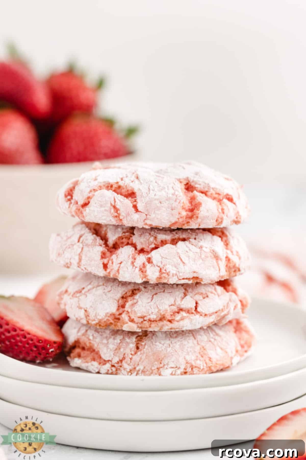 Whipped Strawberry Cloud Cookies 2 Close-up of perfectly baked Strawberry Cool Whip Cookies dusted with powdered sugar, showcasing their soft, crinkled texture and vibrant pink color. A lighter cookie recipe made with strawberry cake mix.