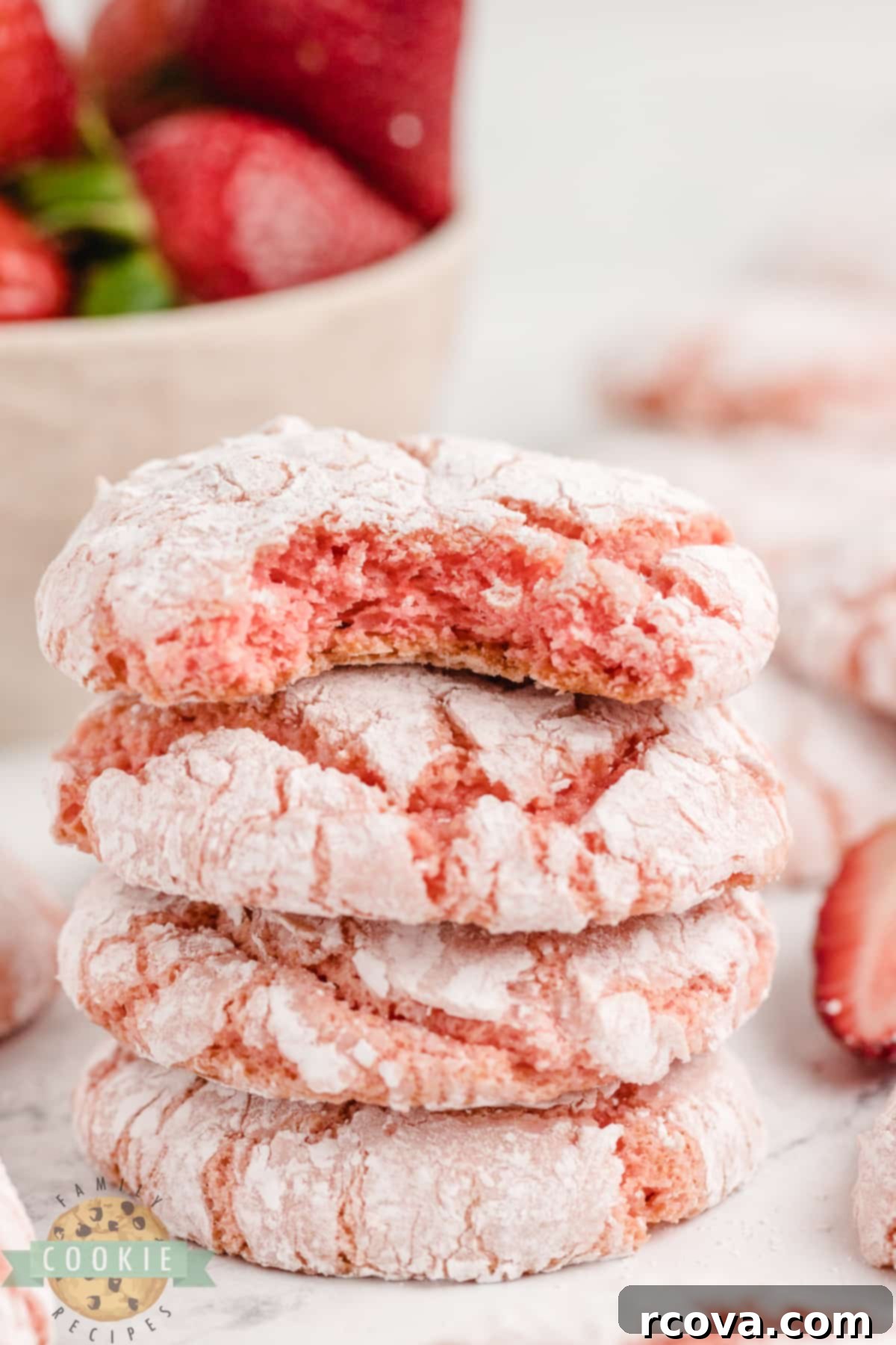 Whipped Strawberry Cloud Cookies 9 Freshly baked strawberry cake mix cookies, still warm and slightly soft, cooling on a rack. Their pink hue and powdered sugar coating make them an attractive dessert.