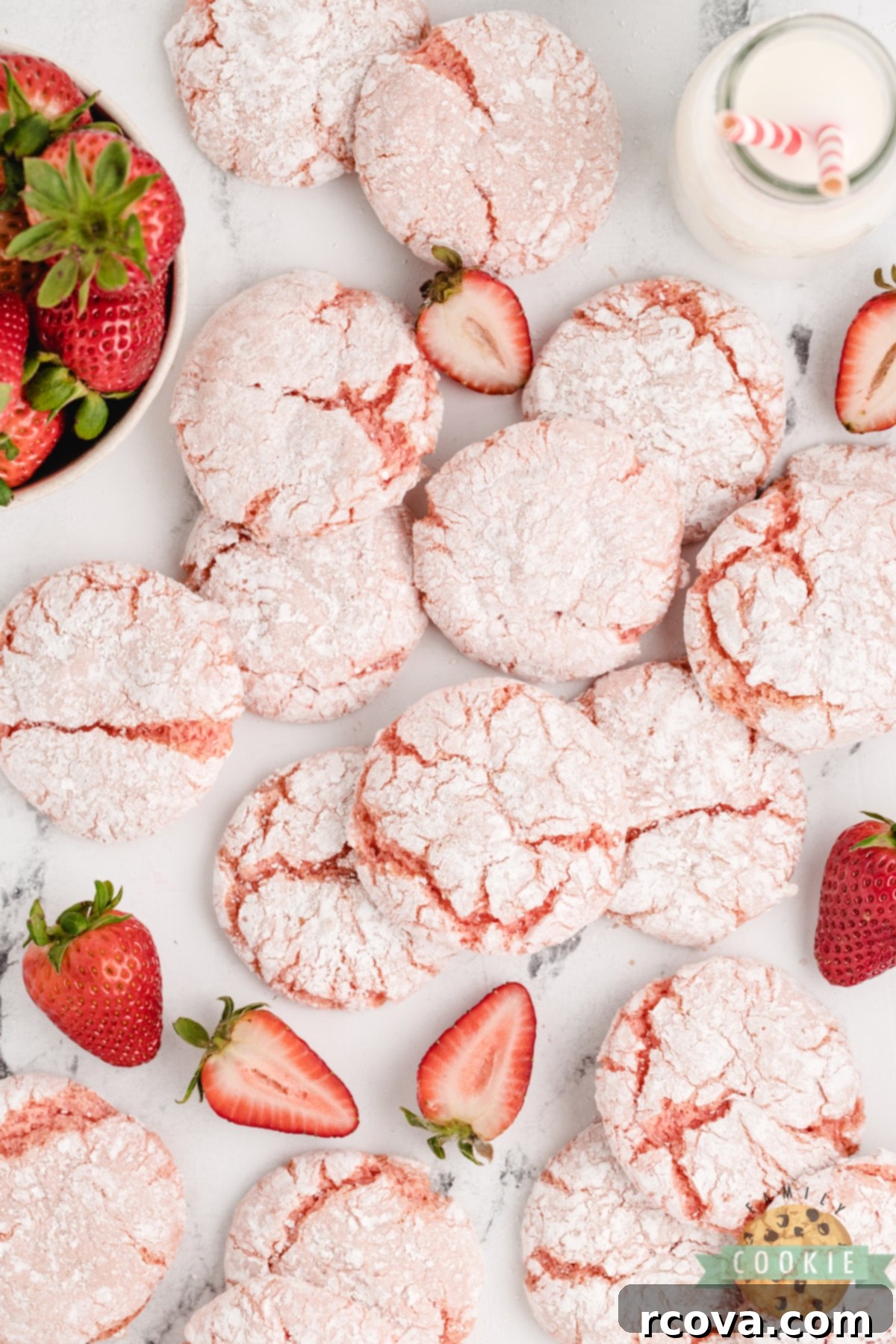 Whipped Strawberry Cloud Cookies 10 A stack of three Strawberry Cool Whip Cookies on a small white plate, showing off their soft, delicate pink interior and powdered sugar coating, inviting a delicious bite.