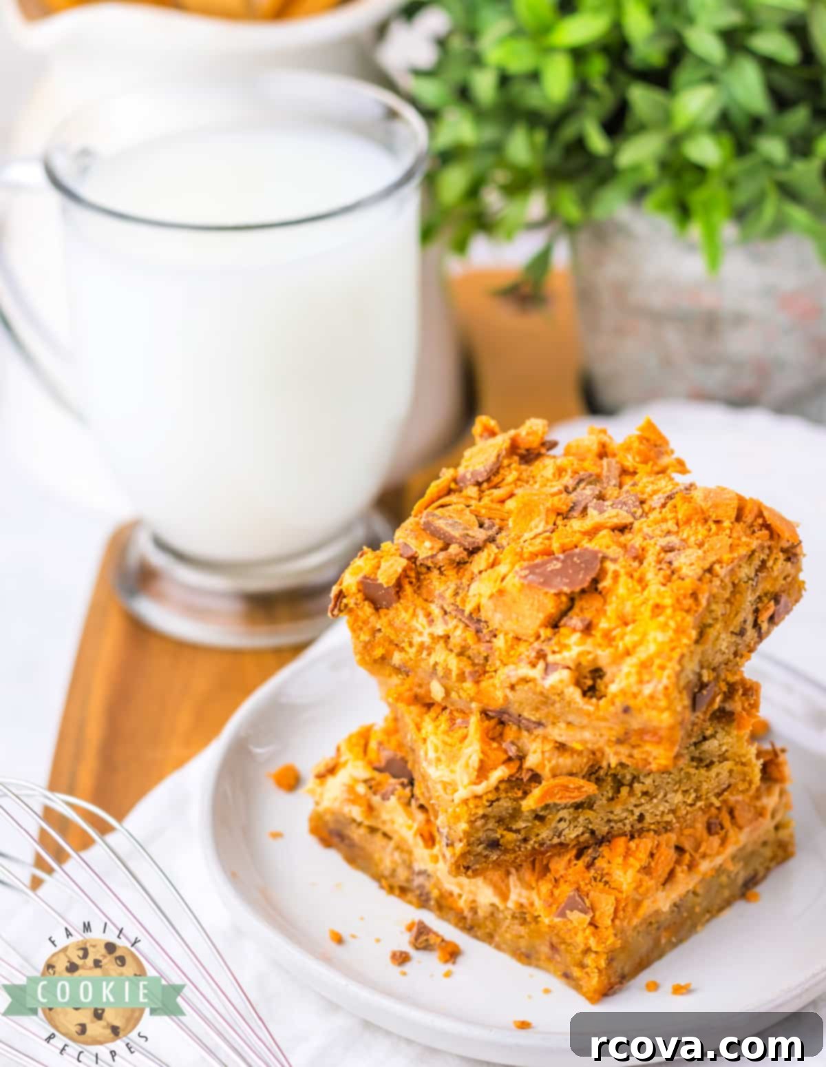 Butterfinger Crunch Cookie Bars 2 Butterfinger Cookie Bars featuring a soft, chewy blondie base, creamy peanut butter frosting, and crushed Butterfinger candy bars.