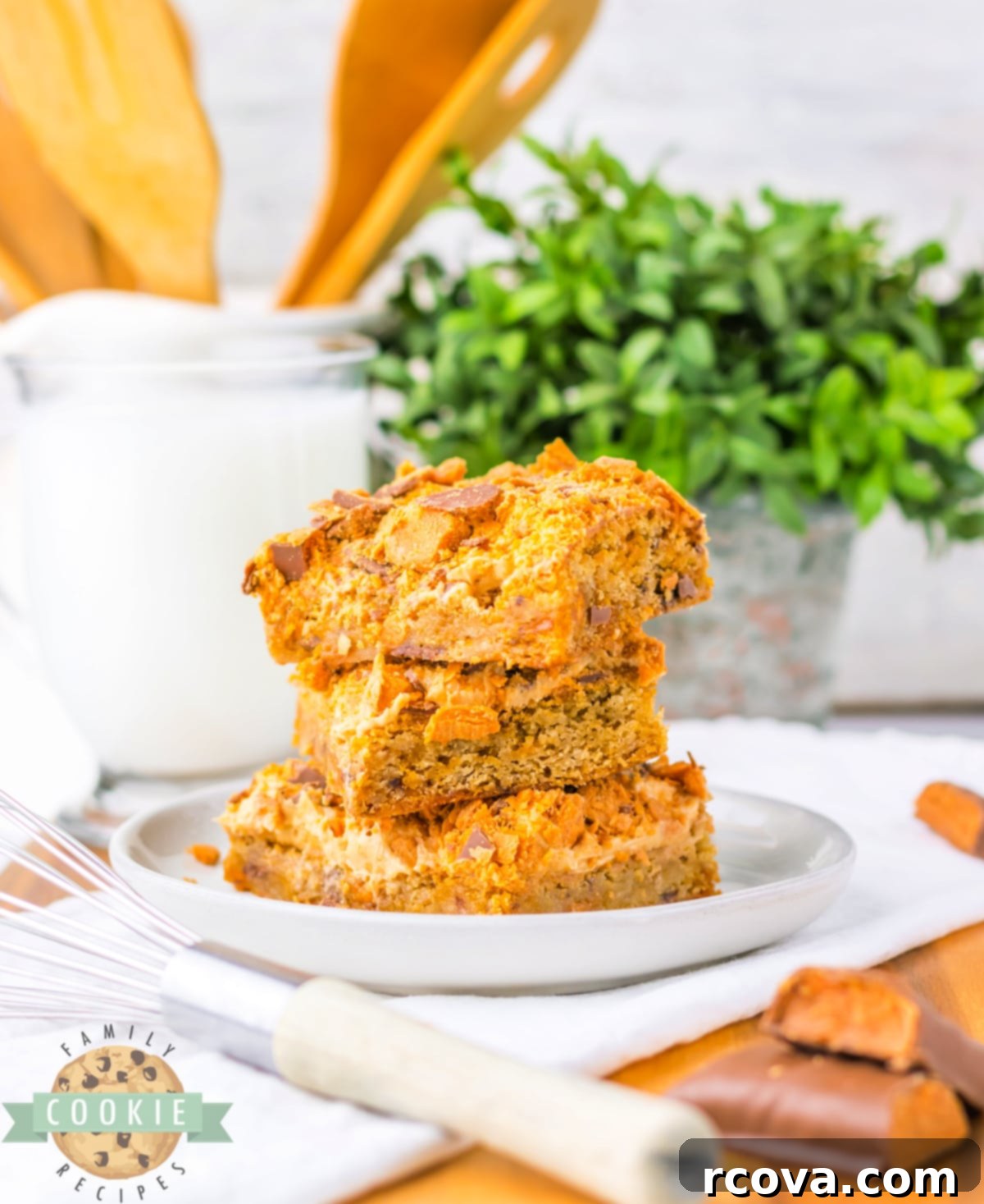 Butterfinger Crunch Cookie Bars 4 A close-up of Butterfinger Cookie Bars, generously topped with creamy peanut butter frosting and an abundance of crushed Butterfinger candy.