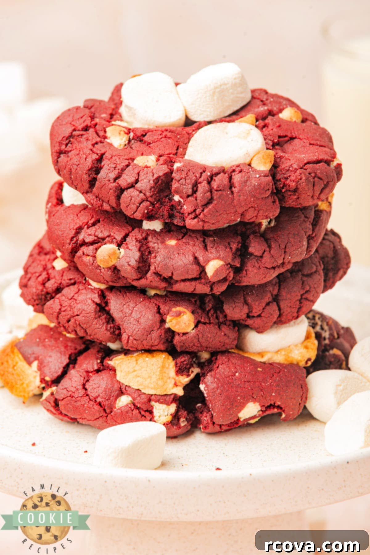 Crimson Cloud Cookies 3 A close-up of homemade red velvet cookies, perfectly baked with melted white chocolate chips and soft mini marshmallows peeking through.