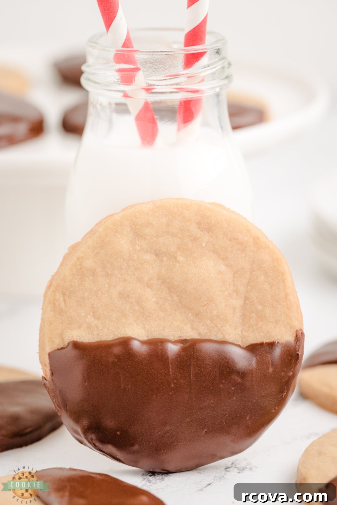 Caramelized Brown Sugar Shortbread 2 Chocolate Dipped Brown Sugar Shortbread Cookies with a glass of milk, highlighting their perfect texture and delicious coating.