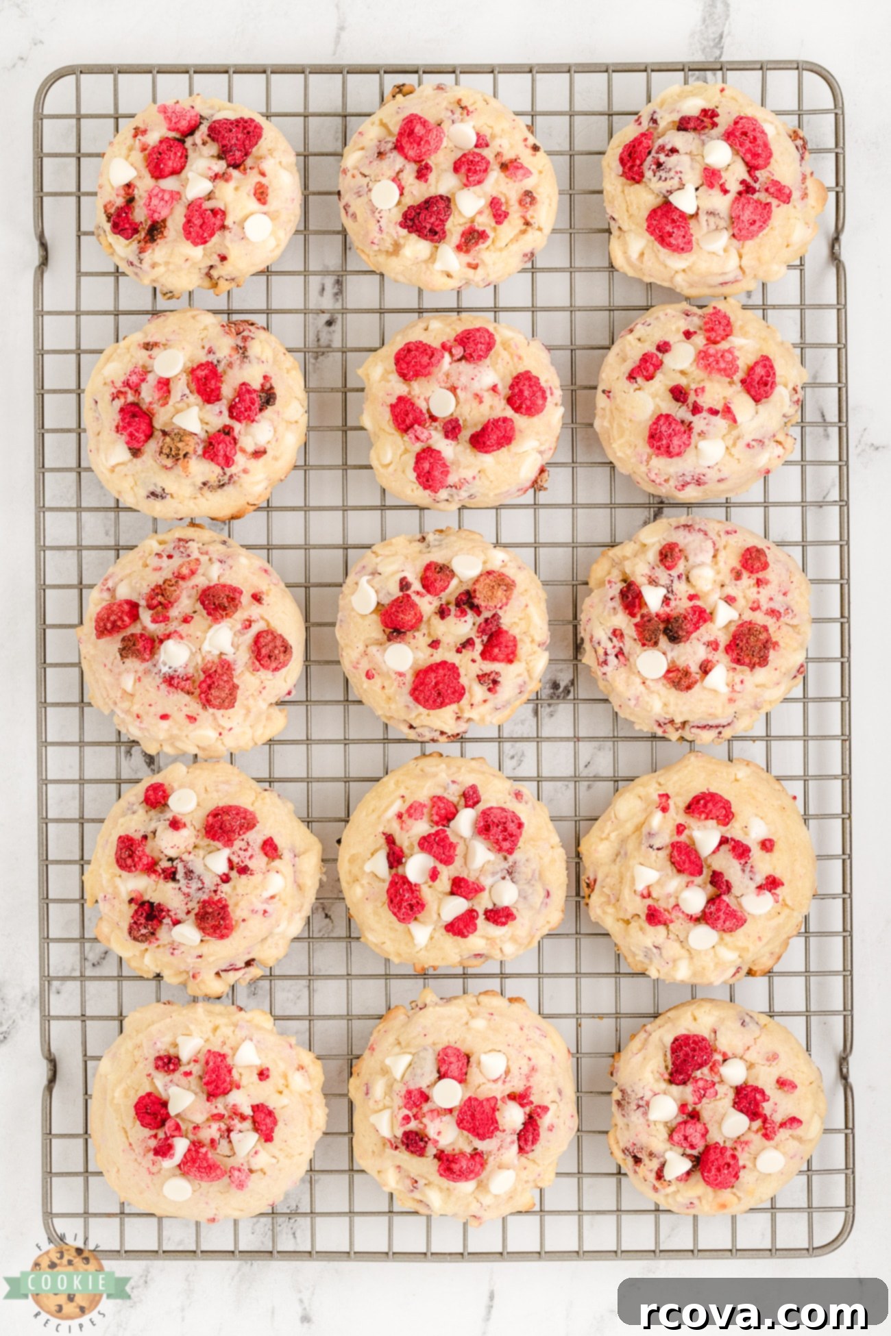 Cheesecake-Filled Raspberry Cookies 6 Freshly baked raspberry cheesecake cookies cooling on a wire rack.