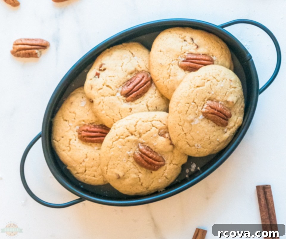 Buttery Pecan Perfection 4 Freshly baked Butter Pecan Cookies cooling on a wire rack.