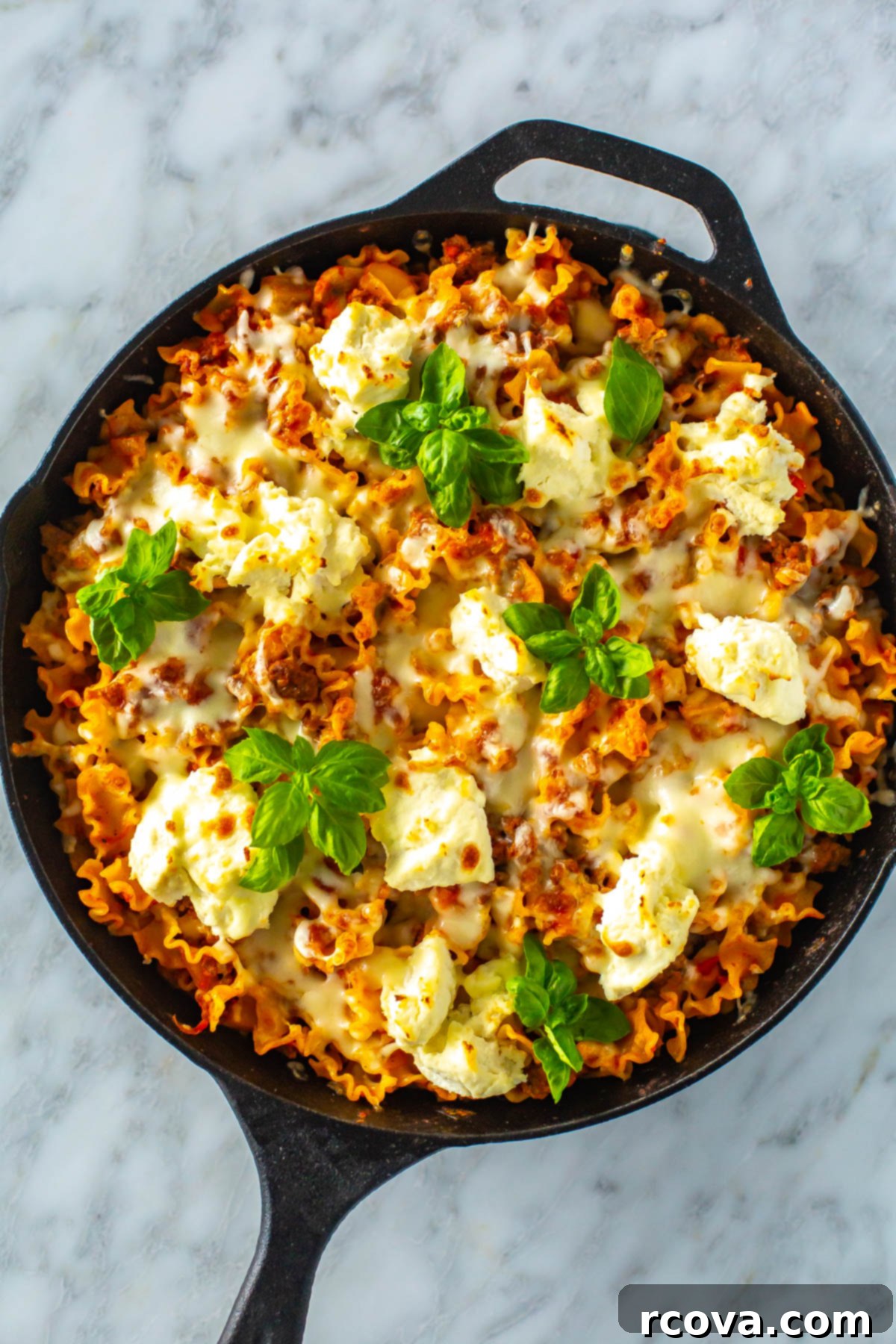 35+ Easy & Healthy 30-Minute Dinners 30 An overhead shot of skillet lasagna garnished with fresh basil.