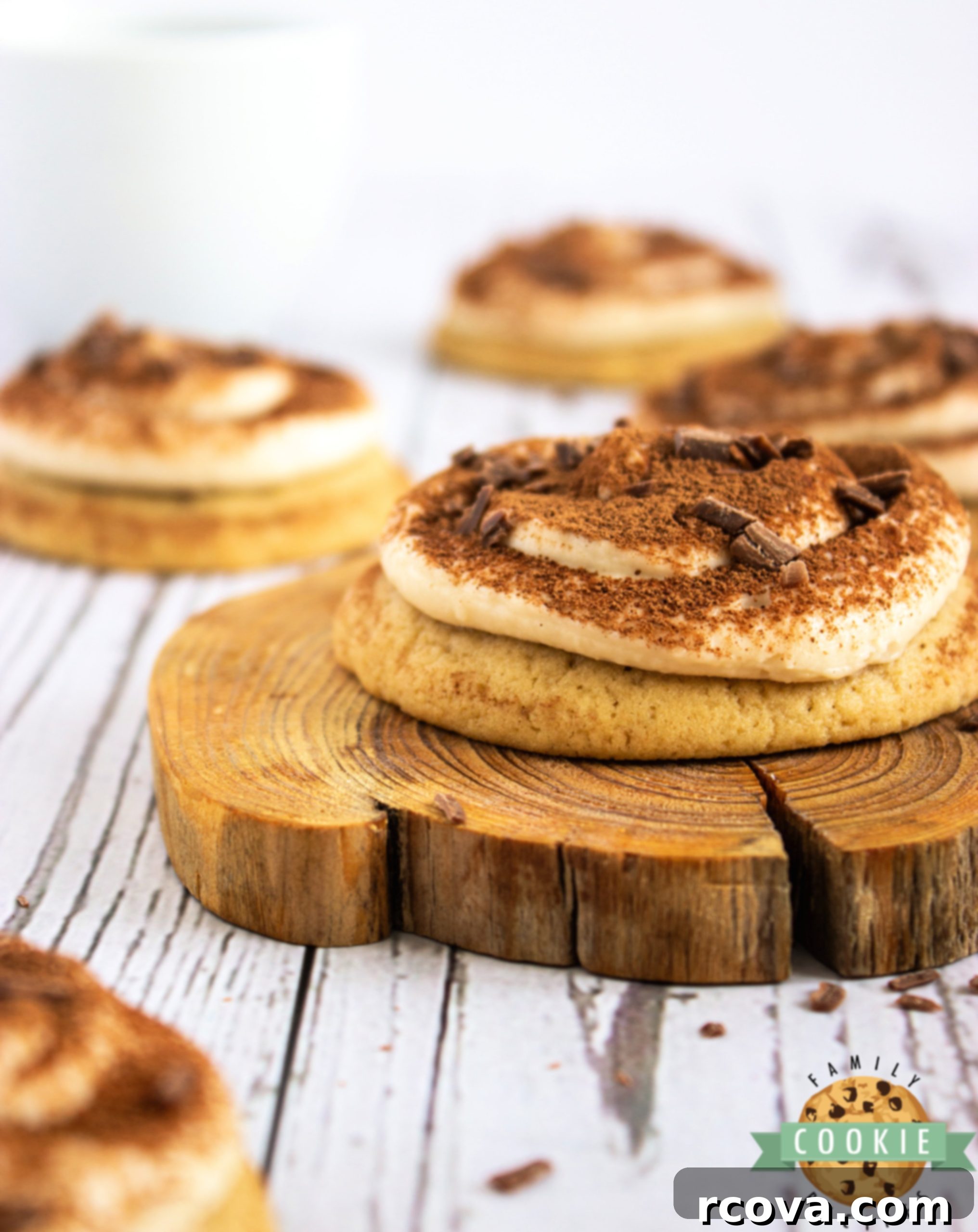 Pillowy Tiramisu Delights 3 Cookies topped with mascarpone frosting and cocoa powder, arranged beautifully.