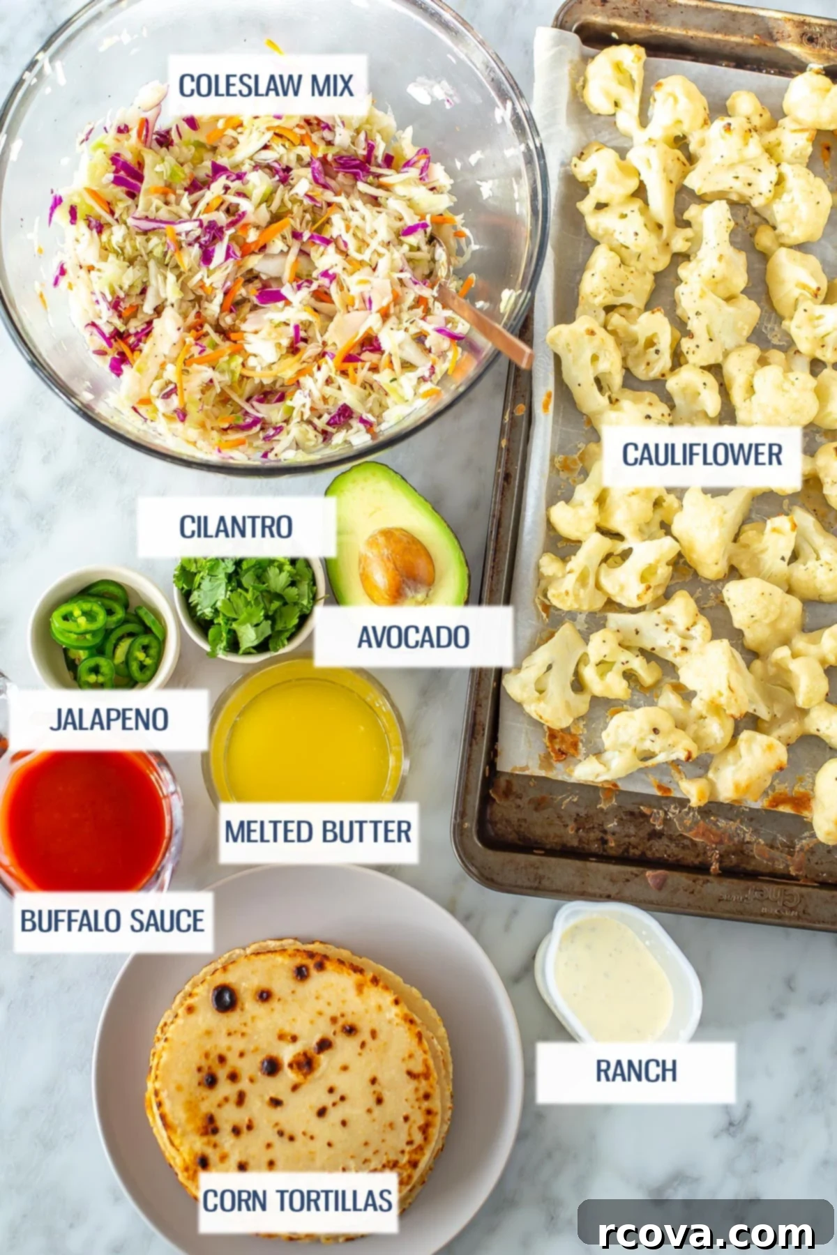 Zesty Buffalo Cauliflower Tacos 4 Ingredients for buffalo cauliflower tacos: coleslaw mix, cauliflower, jalapeno, cilantro, avocado, buffalo sauce, melted butter, corn tortillas, and ranch.
